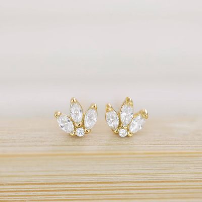 The Coast and Cove Crystal Flower Studs are elegant, delicate earrings featuring a floral design adorned with sparkling crystals.