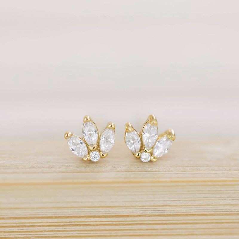 The Coast and Cove Crystal Flower Studs are elegant, delicate earrings featuring a floral design adorned with sparkling crystals.
