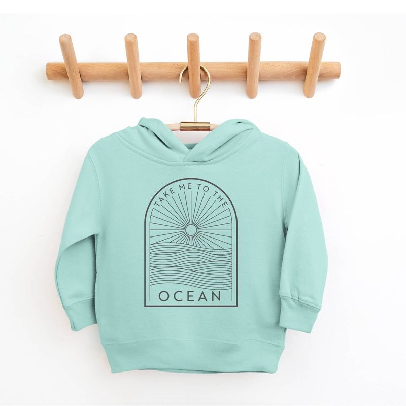 The Take Me to the Ocean Kids Hoodie by Spruce Seed is a cozy and stylish pullover designed for young adventurers. In a soothing Saltwater Blue/Green color, it features a beach coastal theme, perfect for ocean lovers. This unisex fleece hoodie is made for all seasons, ideal for cooler weather or a windy day at the beach.

