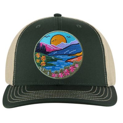The River Mountain Wildflower Patch Trucker Hat by Spruce Seed is a stylish and functional adult snapback hat. It features an embroidered wildflower patch, capturing the beauty of nature. The hat has a mid-profile, structured front panel and a mesh back, making it breathable and comfortable for all-day wear.