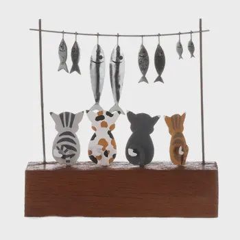 CATS STARING AT FISH FIGURE