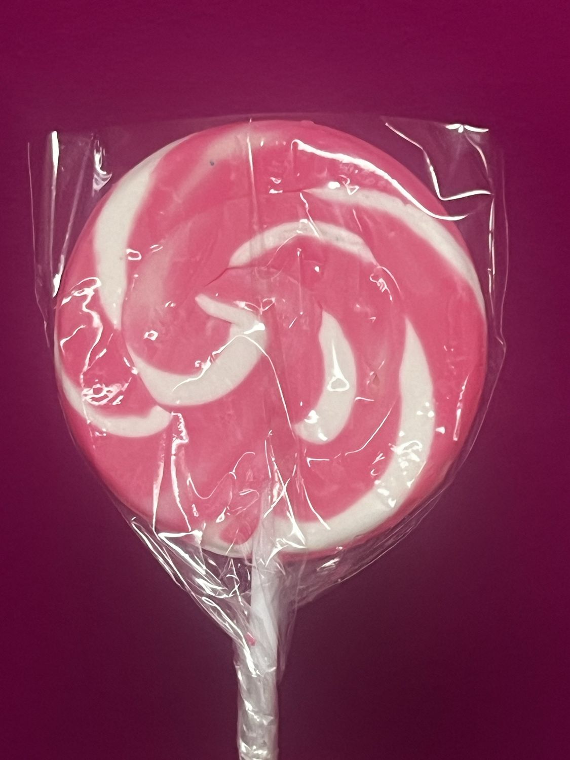 Pink and white swirl lollipop