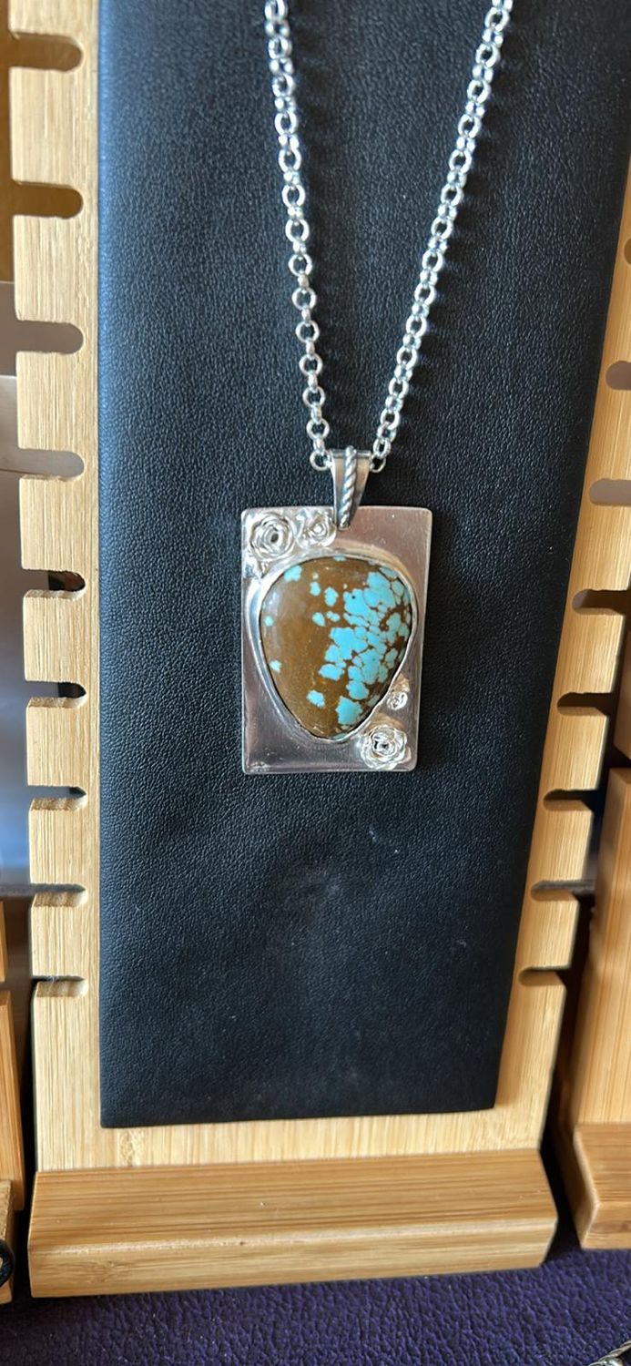 Sterling Silver hand made Rose’s Turquoise cabochon pendant with metal chain. $249