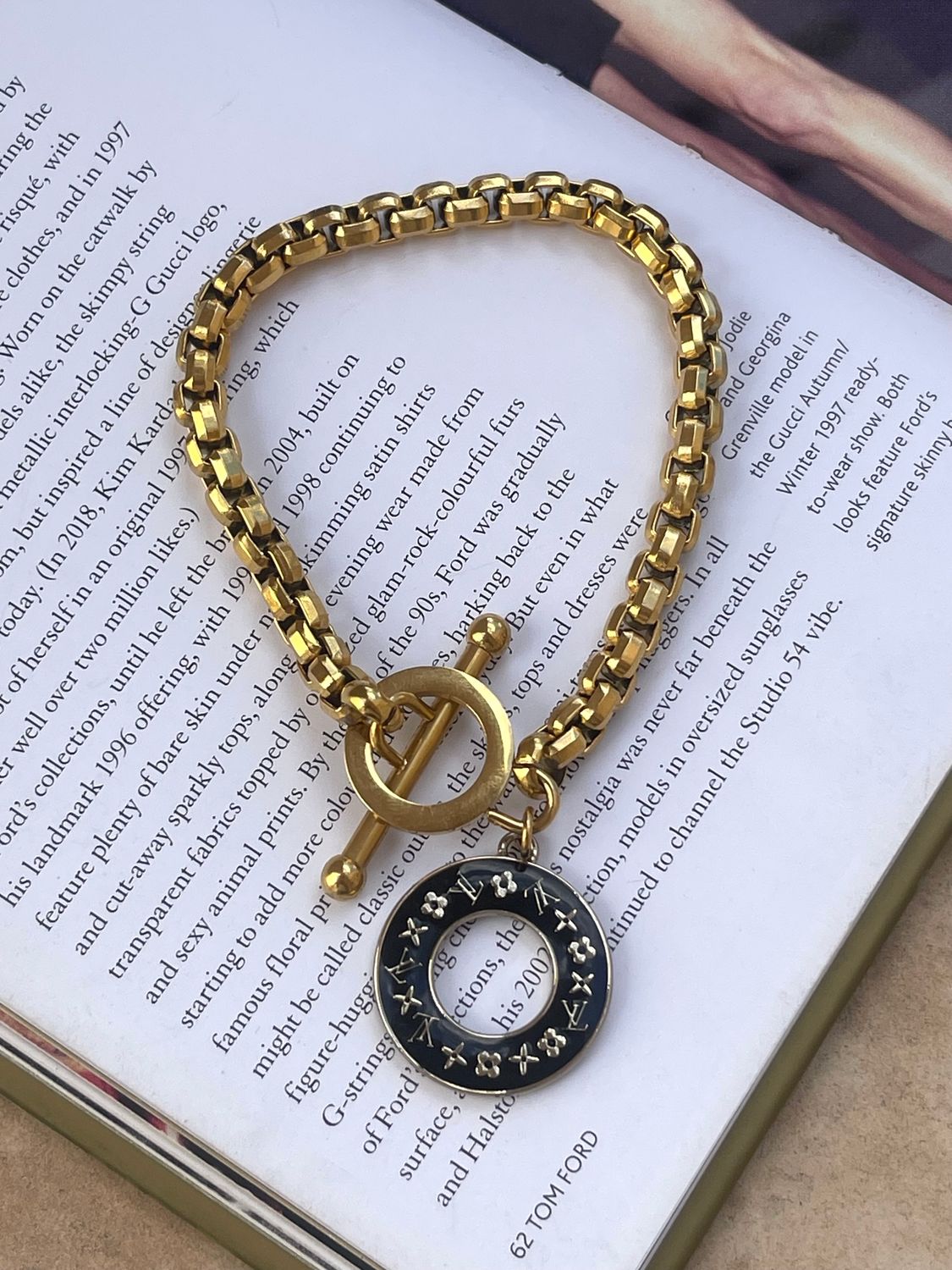 Delicate gold chain with black charm bracelet