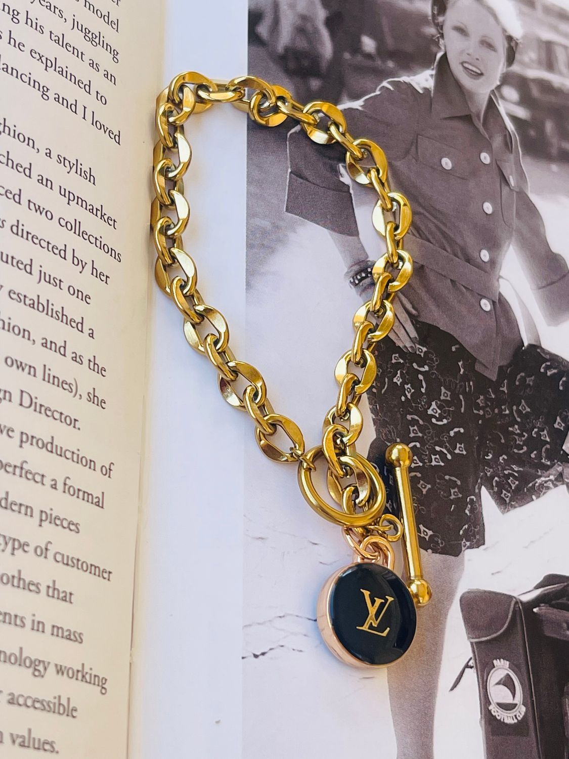 Delicate gold tone bracelet with black charm