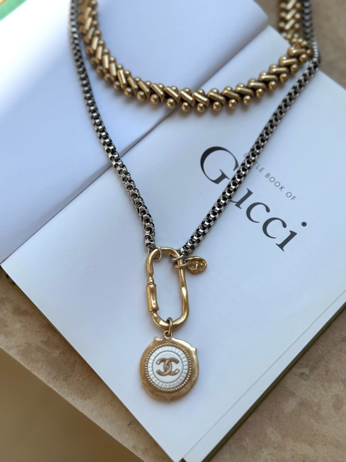 Stylish silver and gold tone necklace with charm