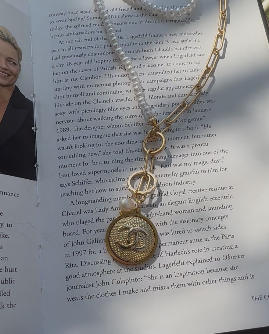 Elegant gold tone necklace with charn
