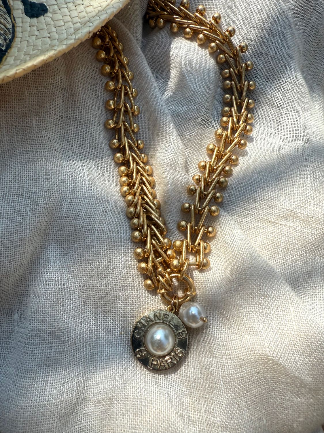 Delicate gold tone necklace with pearl charm