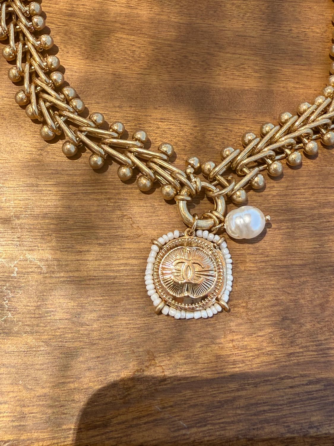 Delicate gold tone necklace with pearl charm