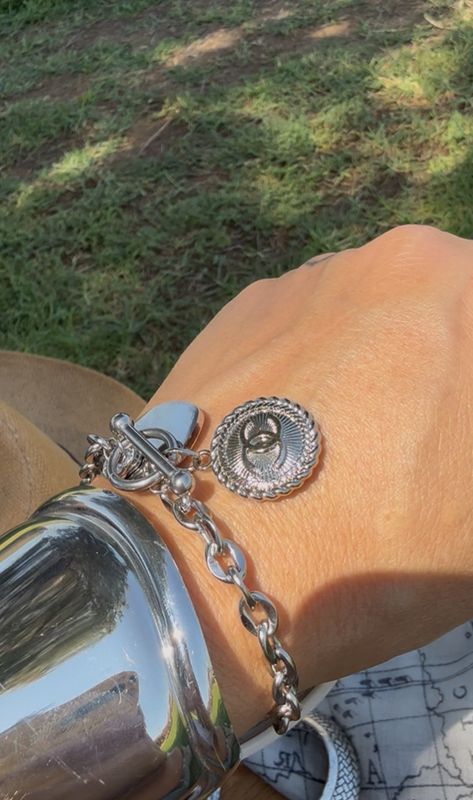 Silver tone bracelet with charm