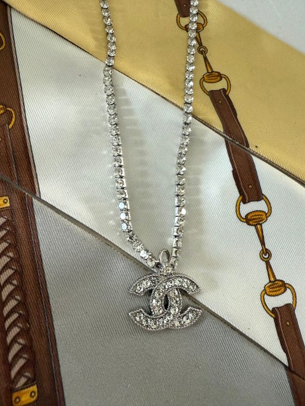 Stylish silver tone chain with rhinestones and logo charm