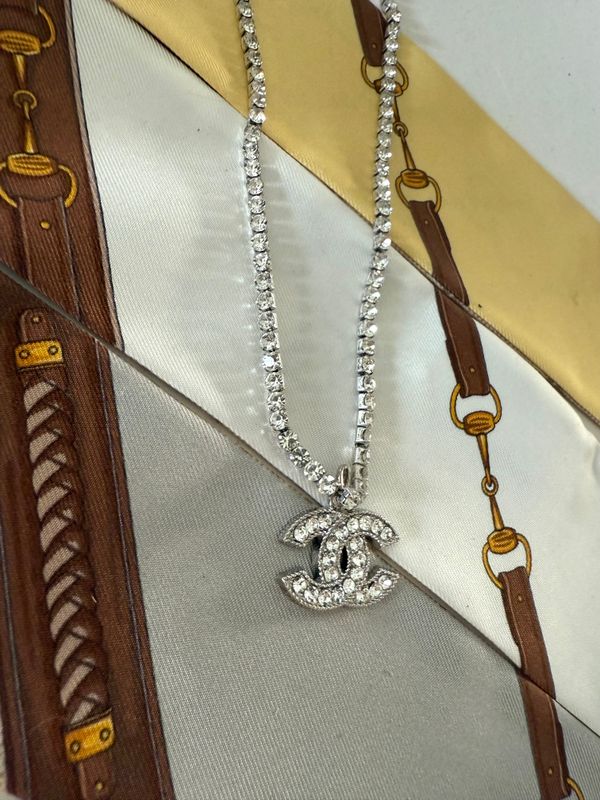 Stylish silver tone chain with rhinestones and logo charm