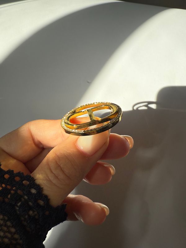 Delicate round logo brooch with rhinestones