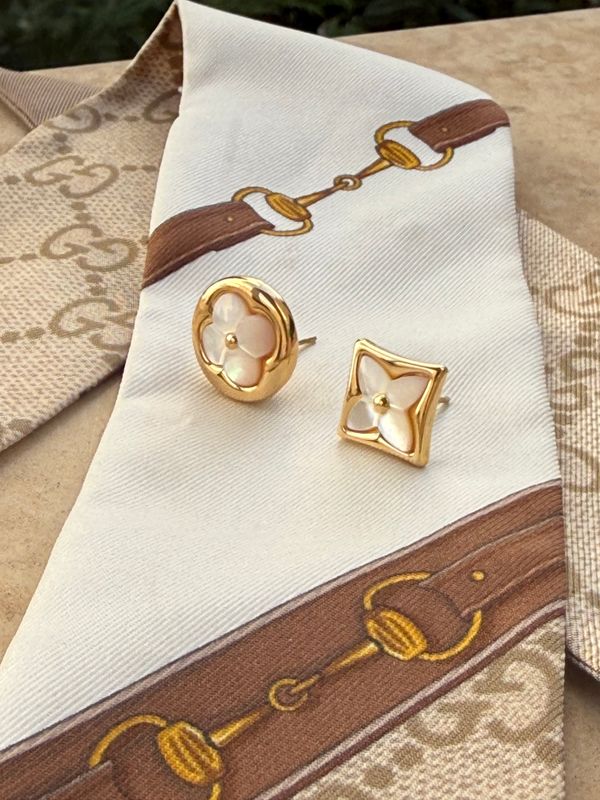Elegant mismatched gold tone pearl earrings