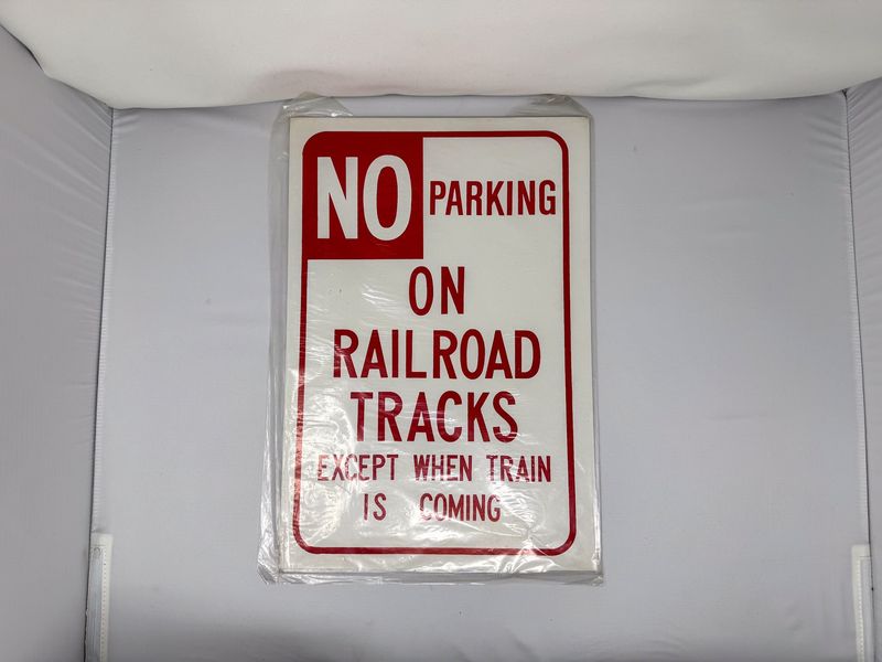 No Parking On Railroad Tracks Except When Train Is Coming Sign