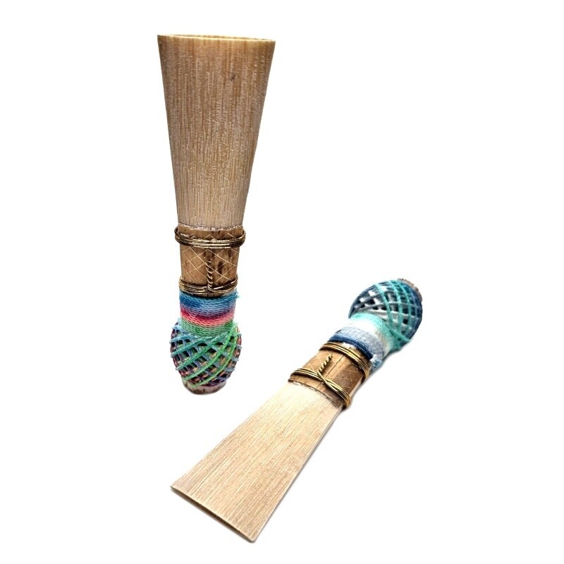 Two ACDC Contrabassoon Reeds, one standing on end and one laying down