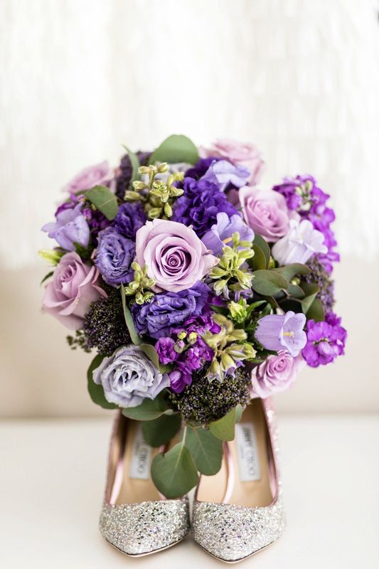 a beautiful purple bridal bouquet featuring roses, stock, and lisianthus for a cape may wedding at congress hall