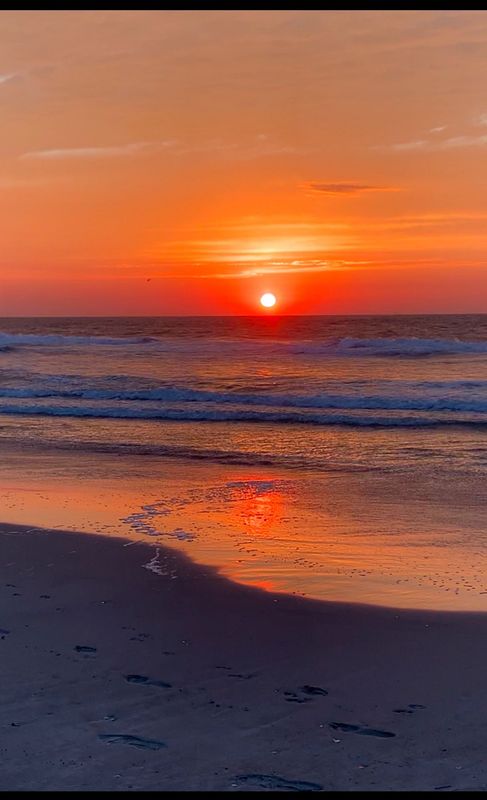 a sunrise on the beach in cape may new jersey