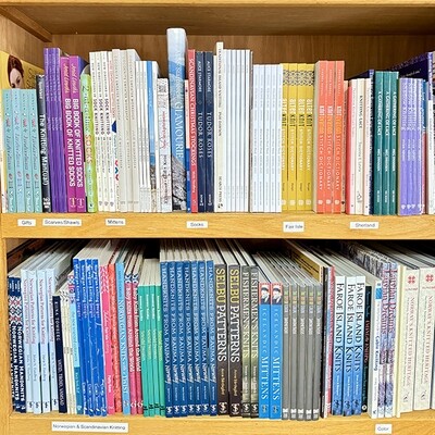 books on a bookshelf, knitting books, crochet books, weaving books