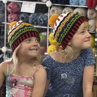 two young girls wearing Ewe-nice crochet hat