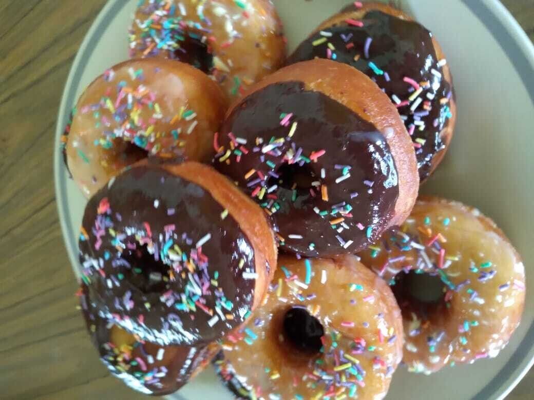 Donuts topped with dark chocolate and sprinkles