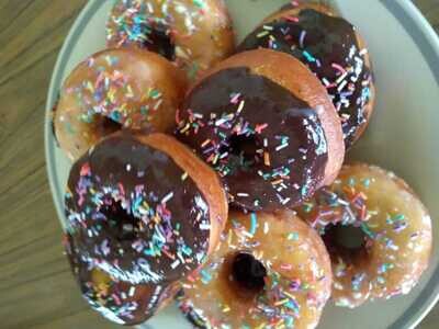 Donuts topped with dark chocolate and sprinkles