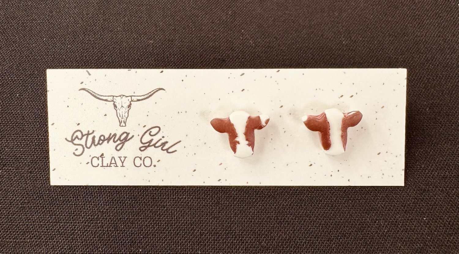 STRONG GIRL CLAY CO. BROWN &amp; WHITE COW HEAD STUDS