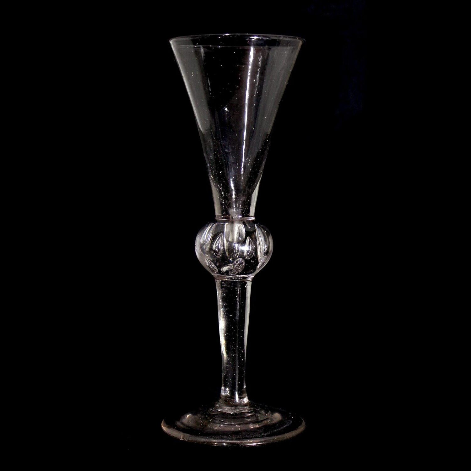 Tall toasting glass with pierced air beads, England, 1st half of the 18th century.