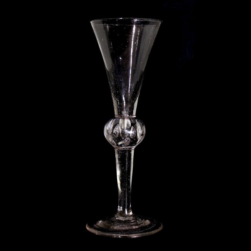 Tall toasting glass with pierced air beads, England, 1st half of the 18th century.