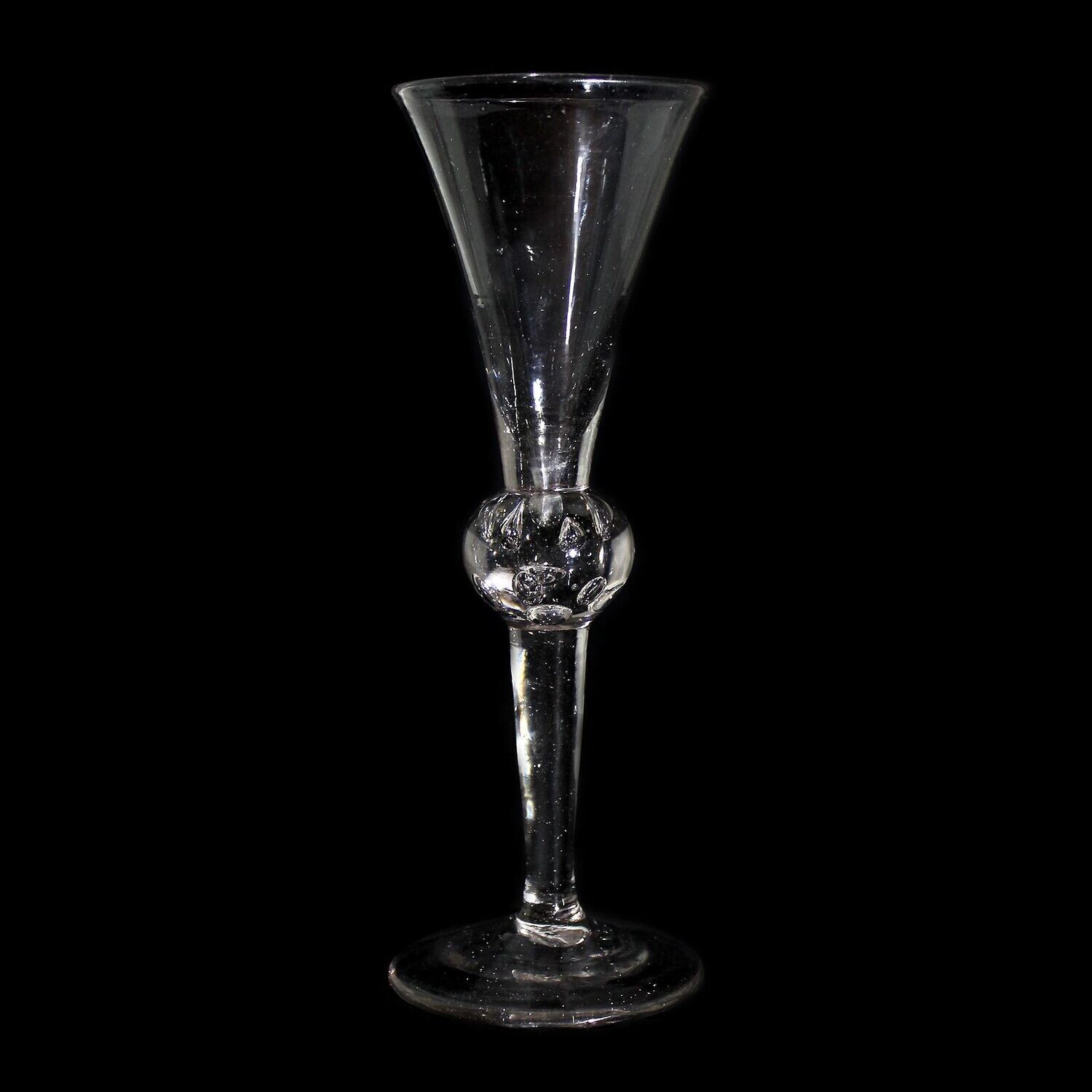 Tall toasting glass with pierced air beads, England, 1st half of the 18th century.