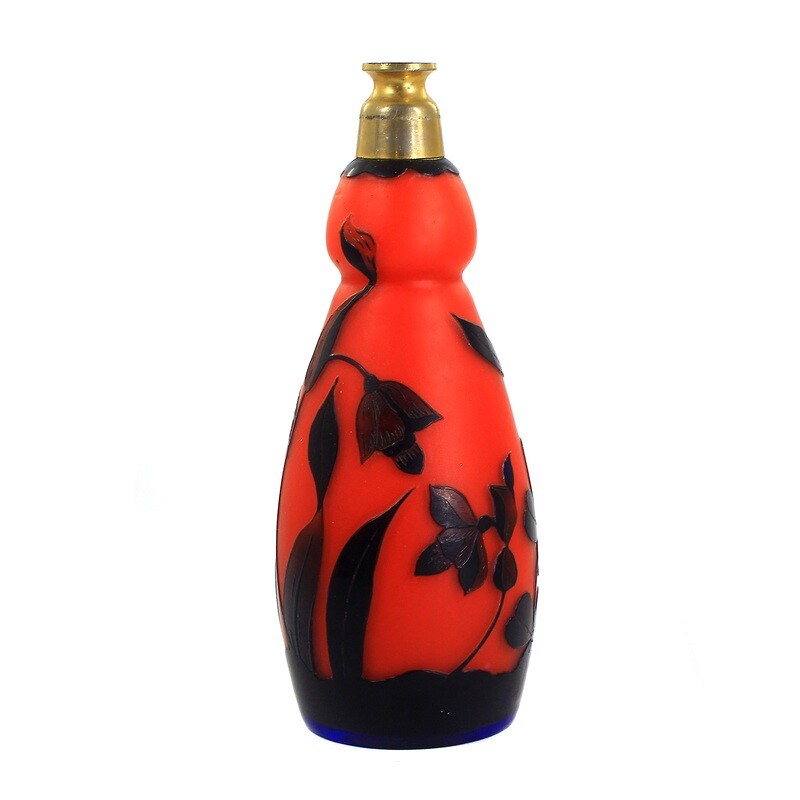 Perfume atomizer made of orange-red glass with blue overlay, probably New World