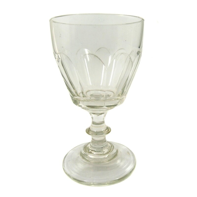 Goblet glass made of colorless glass with arched facets, pressed nodus, mid-19th century.