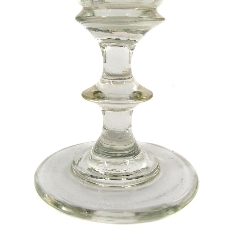 Goblet glass made of colorless glass with arched facets, pressed nodus, mid-19th century.