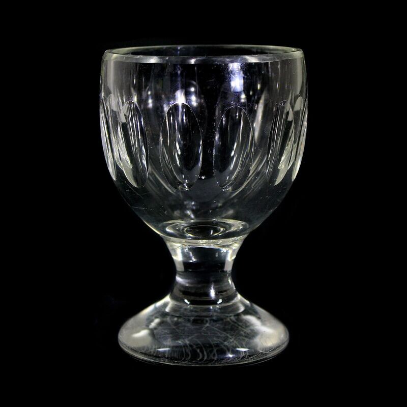 Grog glass made of colorless, thick-walled glass with olive cut, late 19th century.