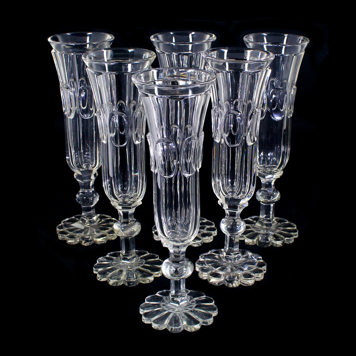 6 Biedermeier champagne flutes made of colorless glass with a highly cut oval medallion