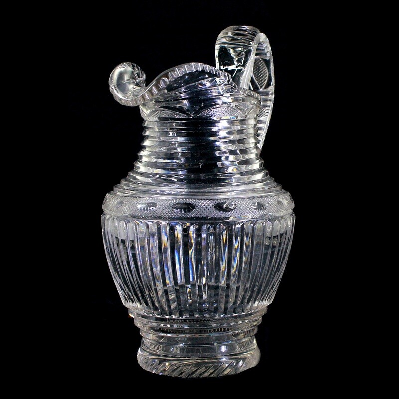 Handle jug made of colorless glass with wedge-cut decoration, Bohemia around 1830.