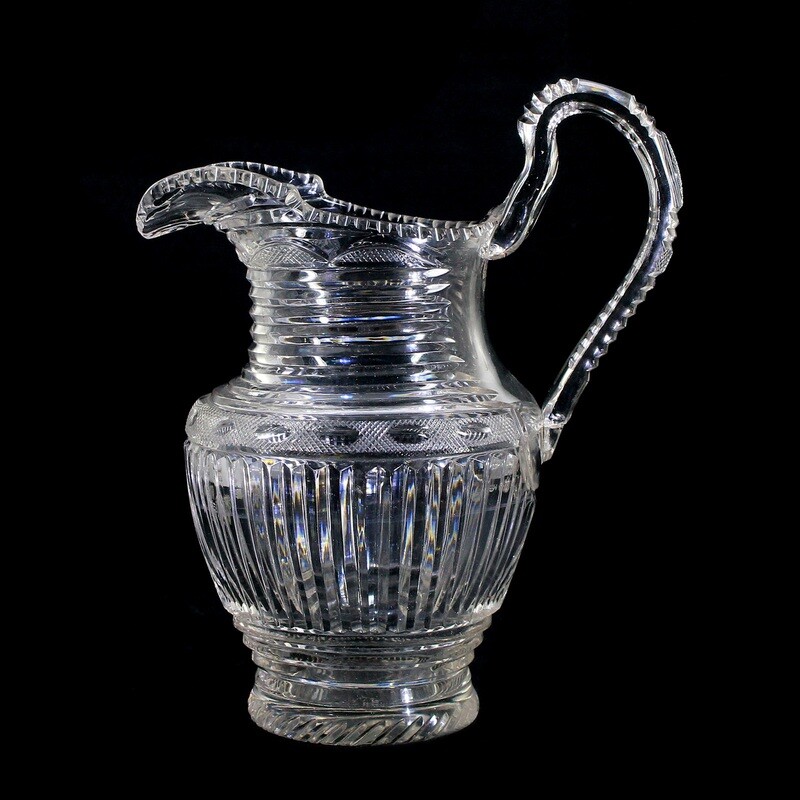 Handle jug made of colorless glass with wedge-cut decoration, Bohemia around 1830.