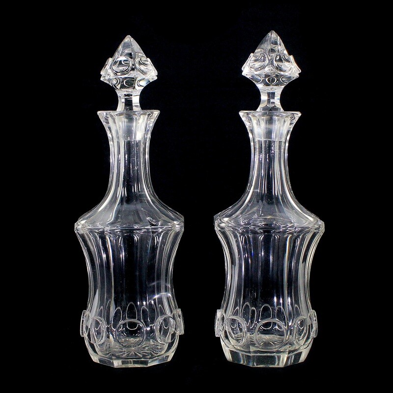 Pair of carafes with stoppers made of colorless glass with a highly cut round medallion.