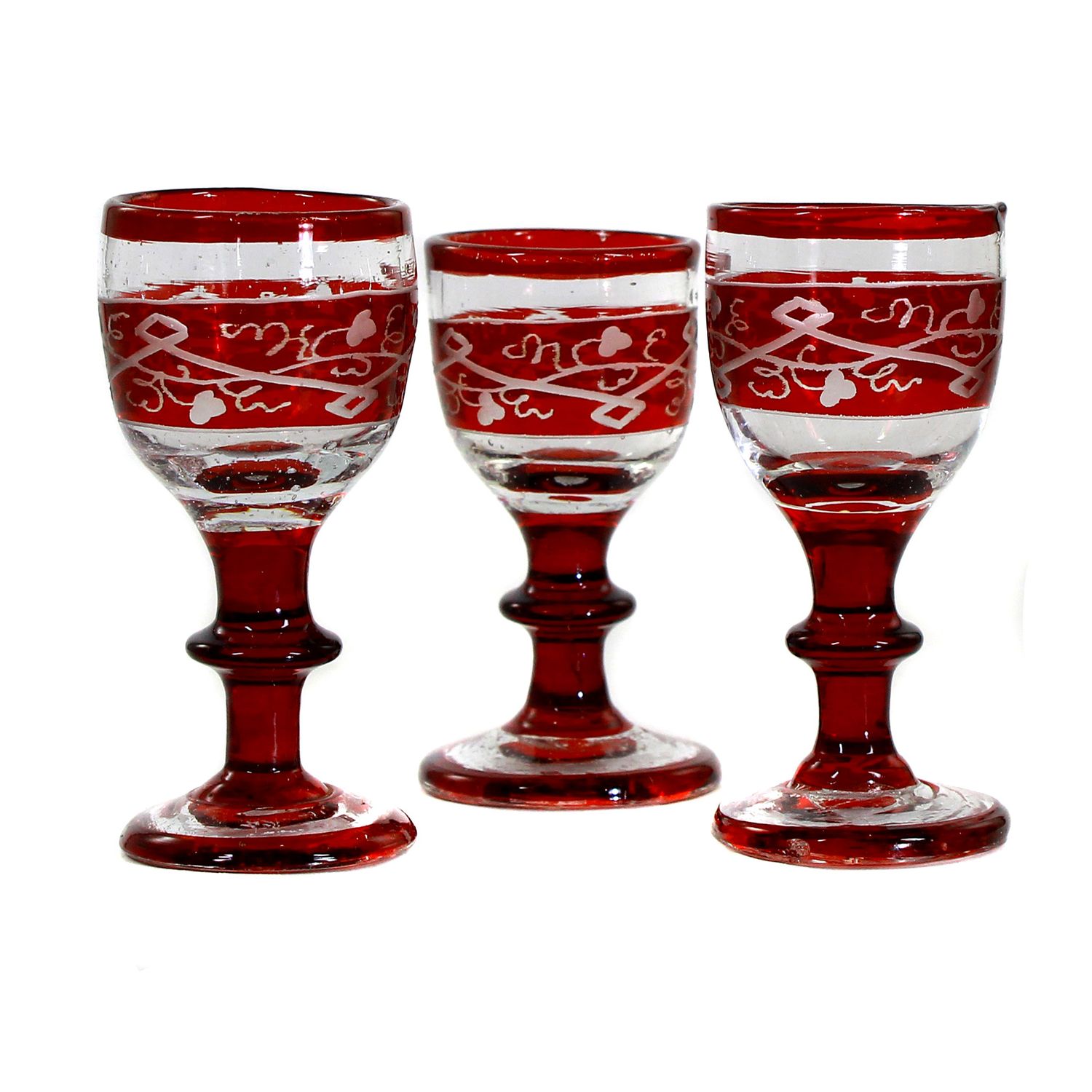 3 liqueur glasses with tear-off, ruby ​​red glazed, with decorative cut decoration, Bohemia, 19th century.
