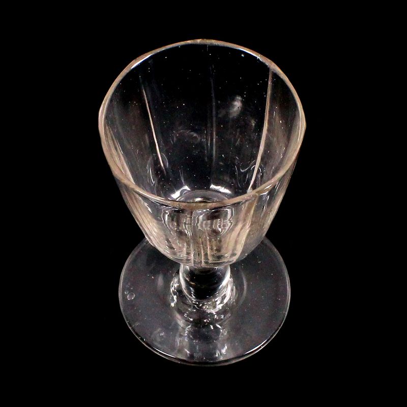 Wine glass made of colorless glass with optically ribbed bowl, North German.