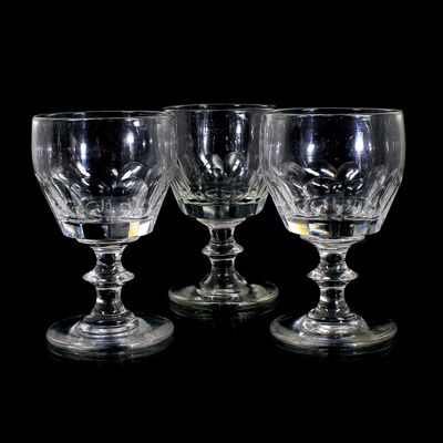 3 goblets made of colorless glass with curved facets and a pressed nodule, mid-19th century.