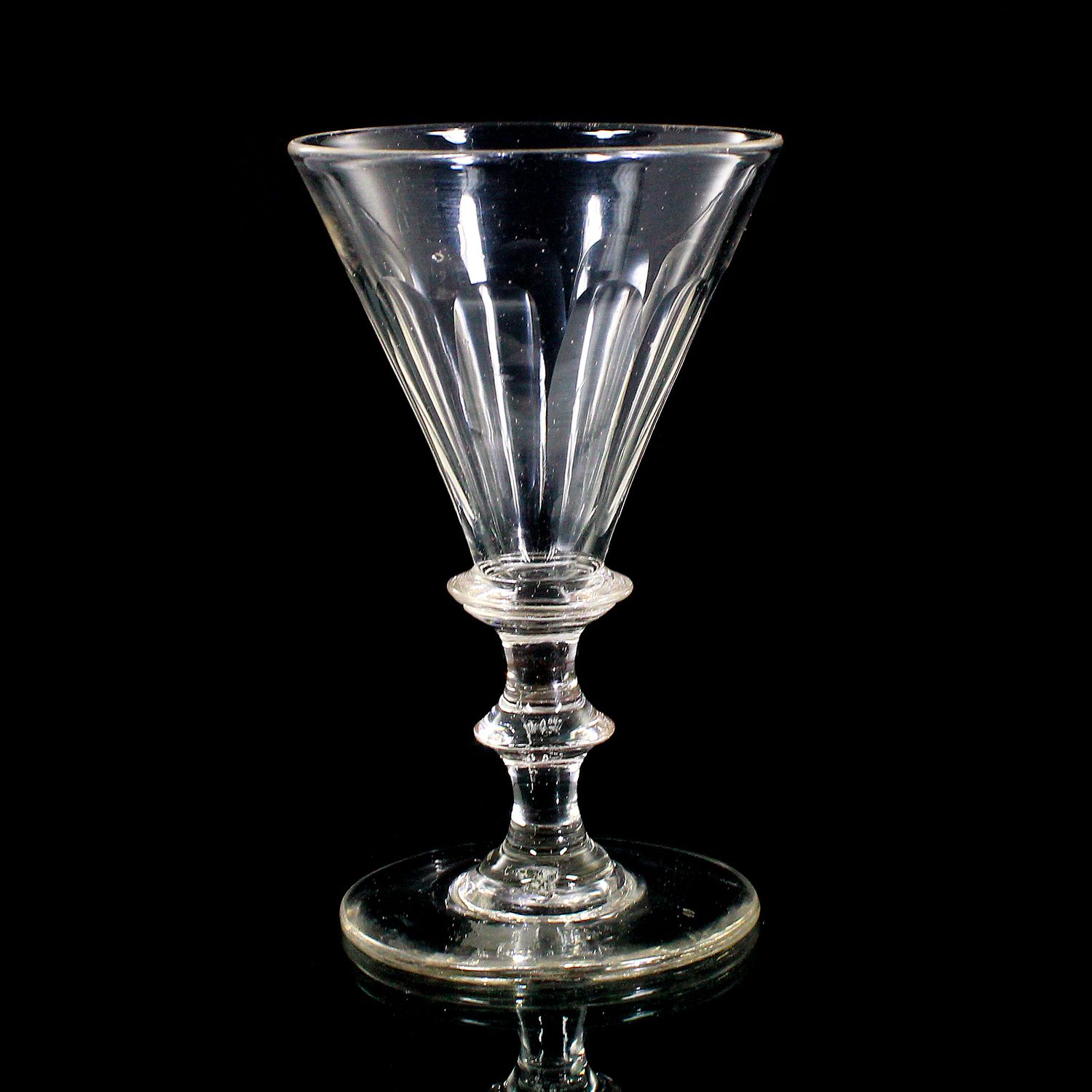Goblet made of colorless glass with arched facets, pressed knop, mid-19th century.