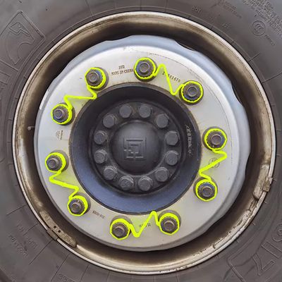 A closeup of a 10-stud wheel with 5 double link wheel nut retainers fitted to adjacent wheel nuts