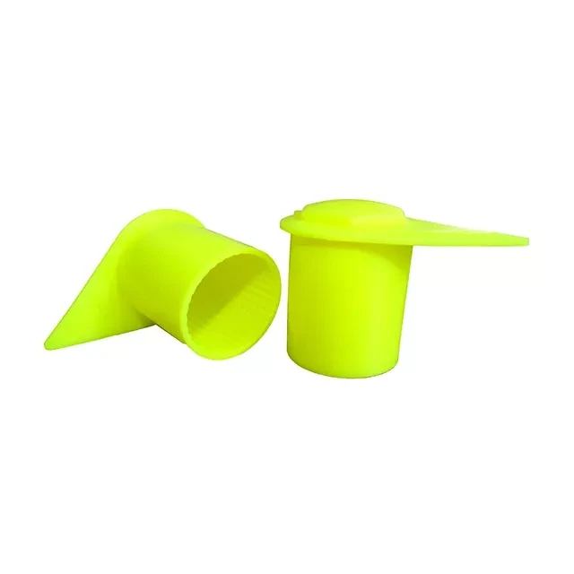 Two 22mm fluorescent yellow long reach dust cap indicators, one sitting vertical, one on its side