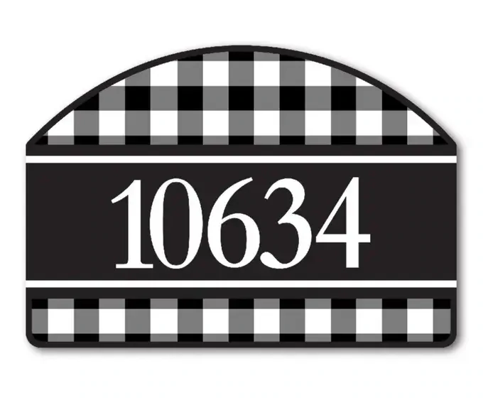Close-up of a black and white buffalo check magnetic yard sign displaying address numbers.