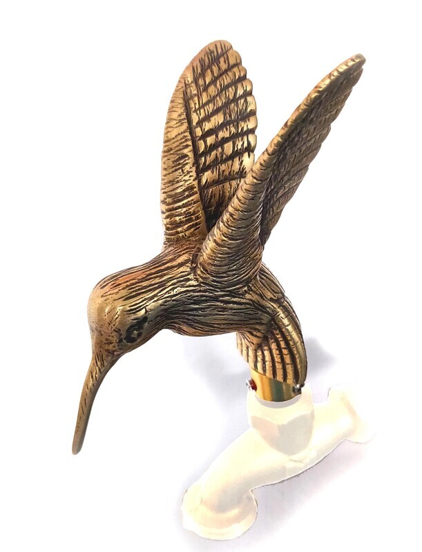 Decorative gold-tone hummingbird outdoor faucet handle with detailed wings and beak.