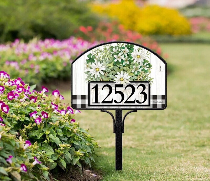 Farmhouse daisies magnetic yard sign with address numbers, installed on a metal stake in a garden.