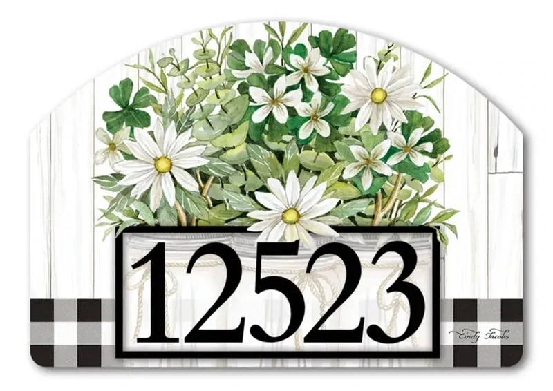 Close-up of magnetic yard sign featuring white daisies in a mason jar and adhesive address numbers.
