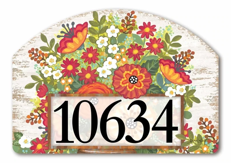 Close-up of a magnetic yard sign design showing autumn flowers, pumpkins, and adhesive address numbers.