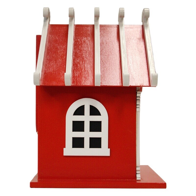 Side profile of the Candy Cane Birdhouse showing the red wood siding and a black arched window detail.